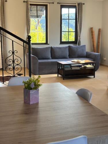a living room with a couch and a table at Pointview House Gesha in Dryanovo