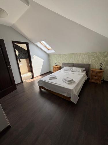 a bedroom with a large bed and a mirror at Pointview House Gesha in Dryanovo