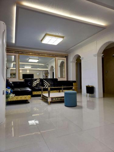 a large room with couches and a large mirror at THE OCEAN Pension in Sokcho