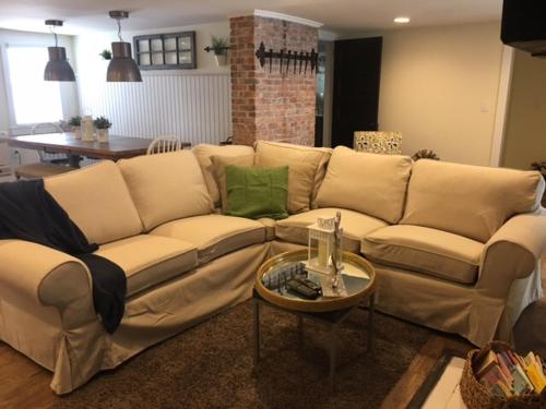 a large couch in a living room with a table at Ocean Manor 1100 Inn in Ocean City