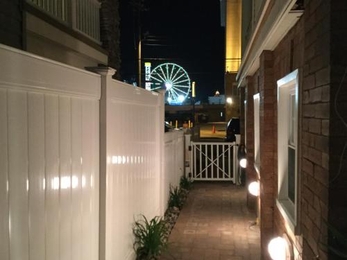 a white fence with a ferris wheel in the background at Ocean Manor 1100 Inn in Ocean City