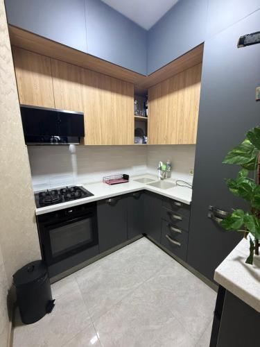 a kitchen with a sink and a stove top oven at Panorama City View Apartment in Tbilisi City