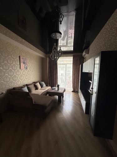a living room with a couch and a table at Panorama City View Apartment in Tbilisi City