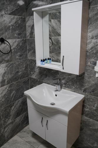 a bathroom with a white sink and a mirror at Turk Art Hotel in Istanbul