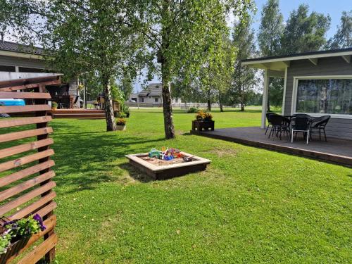 a backyard with a fire pit in the grass at Small house with sauna in Papsaare