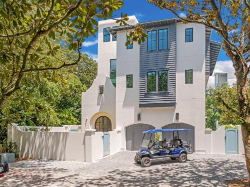 a golf cart parked in front of a house at Summer Nights in Santa Rosa Beach