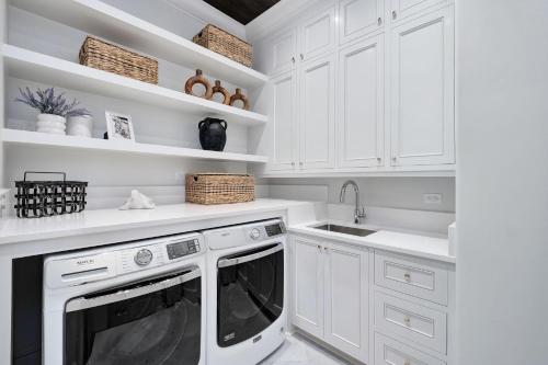 a kitchen with white cabinets and a dishwasher at Summer Nights in Santa Rosa Beach
