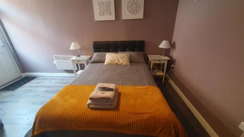 a bedroom with a bed with towels on it at The Savile - Luxury Apartment Leeds - Your Next Stay in Leeds