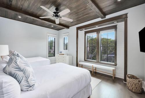 a bedroom with two beds and a ceiling fan at Summer Nights in Santa Rosa Beach
