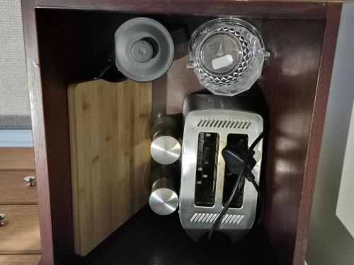 a wooden box with a cutlery in it at Striped Horse Guest House in Cape Town