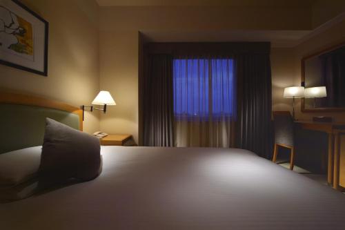 Katil atau katil-katil dalam bilik di Royal Pines Hotel Urawa