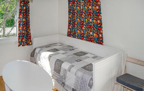 a white room with a bed and a window at Nice Home In Norrtälje in Norrtälje