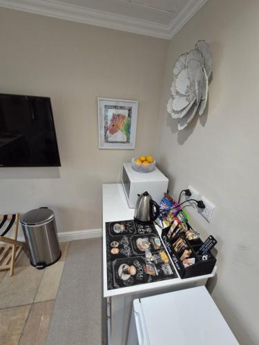 a kitchen with a counter with a stove with food on it at Striped Horse Guest House in Cape Town
