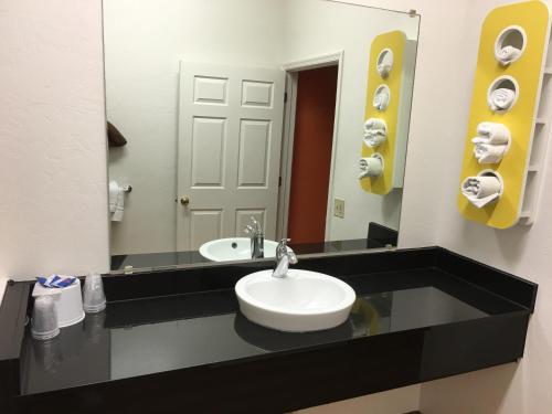 a bathroom with a sink and a mirror at Motel 6-Globe, AZ in Globe