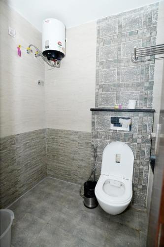 a bathroom with a white toilet in a room at Ima Ganga Hotel - Aesthetic, Quite Mountain View Rooms with netflix, free airport pickup for 7 or more nights booking in Rishīkesh