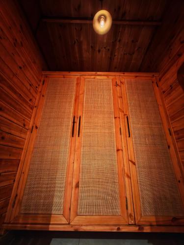 a wooden door in a room with a ceiling at The Clouds Resort Goa in Goa