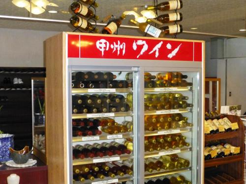 a refrigerator filled with lots of bottles of wine at Kawaguchiko Lakeside Hotel in Fujikawaguchiko