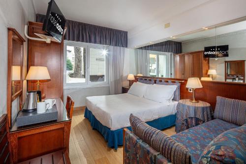 Postel nebo postele na pokoji v ubytování Hotel Astro