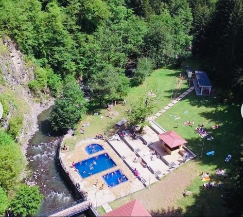 an aerial view of a swimming pool next to a river at Park flat in Borjomi