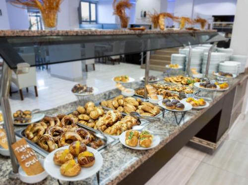 a buffet line with different types of pastries on plates at Tugra Suit Hotel Halal All Inclusive in Alanya