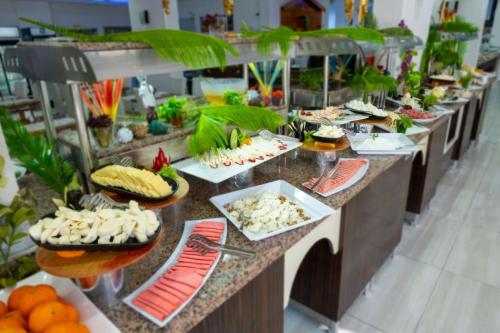 a buffet line with many plates of food on them at Tugra Suit Hotel Halal All Inclusive in Alanya