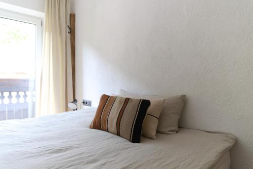 a bedroom with a bed with a pillow on it at Cosy & Style Zell am See in Schmitten