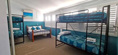 a room with two bunk beds and a bed at Sawtell Hotel in Sawtell