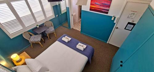 a hospital room with a bed and a table and chairs at Sawtell Hotel in Sawtell