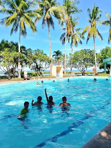 a group of kids in the swimming pool at Palmas Del Mar Resort Bacolod in Bacolod