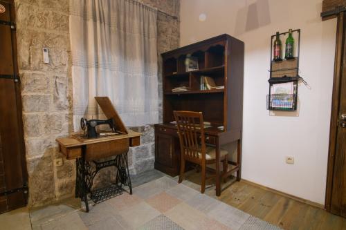 a room with a desk and a chair and a table at Bed & Wine Djonovic in Virpazar