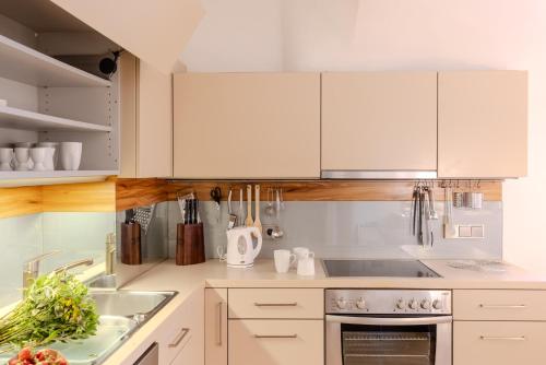 a kitchen with white cabinets and a sink at FrauFuchs in Mautern