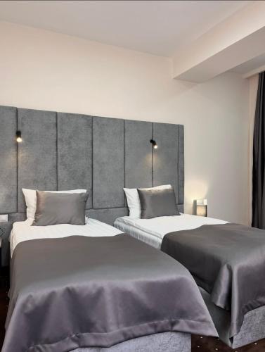 two beds in a room with two beds sidx sidx sidx sidx at Jermuk Verona Resort in Jermuk