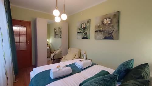 a bedroom with two beds with towels on them at Zacisze Stasia Ustroń 