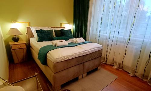a bedroom with a bed with two towels on it at Zacisze Stasia Ustroń 
