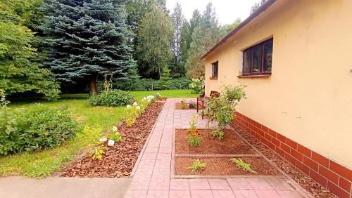 a garden with some plants and a house at Zacisze Stasia Ustroń 
