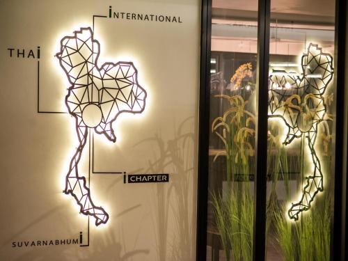a pair of stained glass flowers with lights on a door at iChapter Hotel Suvarnabhumi in Samutprakarn