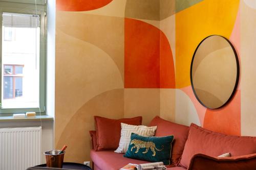 a living room with a couch and a mirror at Fragola Apartments Old Town in Kraków