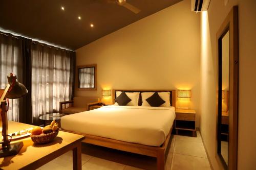 a bedroom with a large white bed and a table at The Artist House Levelup Boutique in Udaipur