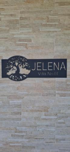 a sign on a wooden floor with a logo on it at Rural stay Miranovic in Balabani