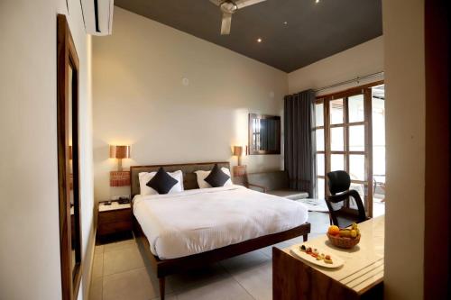 a bedroom with a bed and a desk with a chair at The Artist House Levelup Boutique in Udaipur