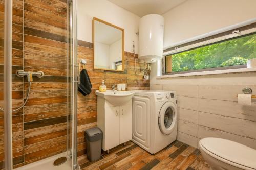 a bathroom with a washing machine and a sink at Bike chata Klopenka na Trutnov Trails in Trutnov