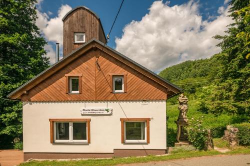a house with a clock tower on top of it at Bike chata Klopenka na Trutnov Trails in Trutnov