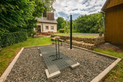 a metal grate in the ground in a yard at Bike chata Klopenka na Trutnov Trails in Trutnov