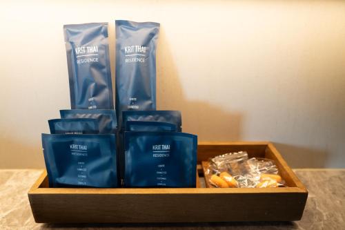 a wooden box filled with blue products on a table at Kritthai Residence in Bangkok