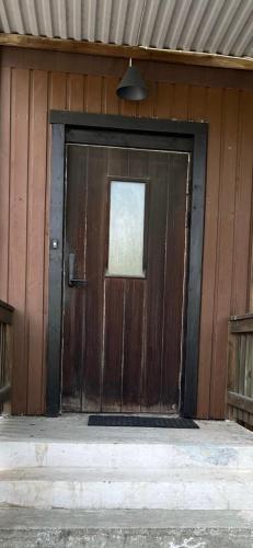 a wooden door of a building with a window at Mindre lägenhet med stora möjligheter in Alingsås