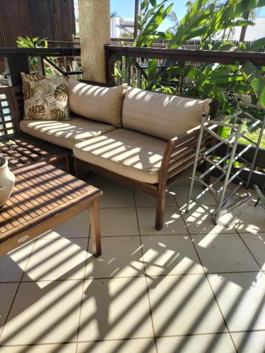 a couch sitting on top of a patio at Ylang Ylang in Saint-Leu