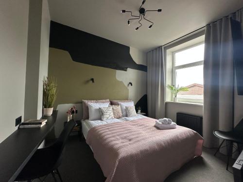 a bedroom with a large bed and a window at RixStay Apartments in Rīga