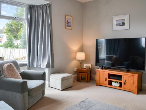 a living room with a large flat screen tv at Eldon Cottage in Hornsea