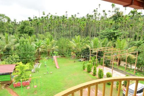 a playground in a garden with trees in the background at DELIGHTFUL HOMESTAY in Sollebail
