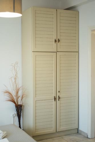 a bedroom with a closet with white cabinets at Spacious Apartment in Mytilene in Mytilini